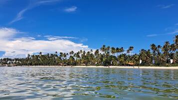 On the beach, white sand, sun-loungers, beach umbrellas