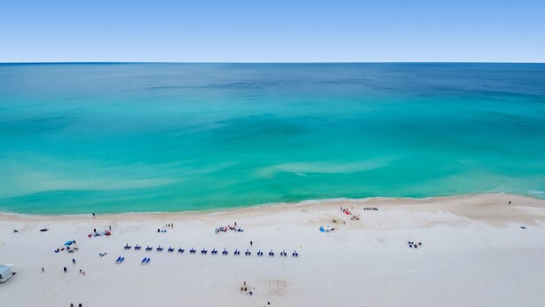 A beach with clear turquoise waters and a sandy shore. -  ⛱️Gulf Front Master-3BR Majestic Beach Towers 1-1804⛱️ (Panama City Beach)