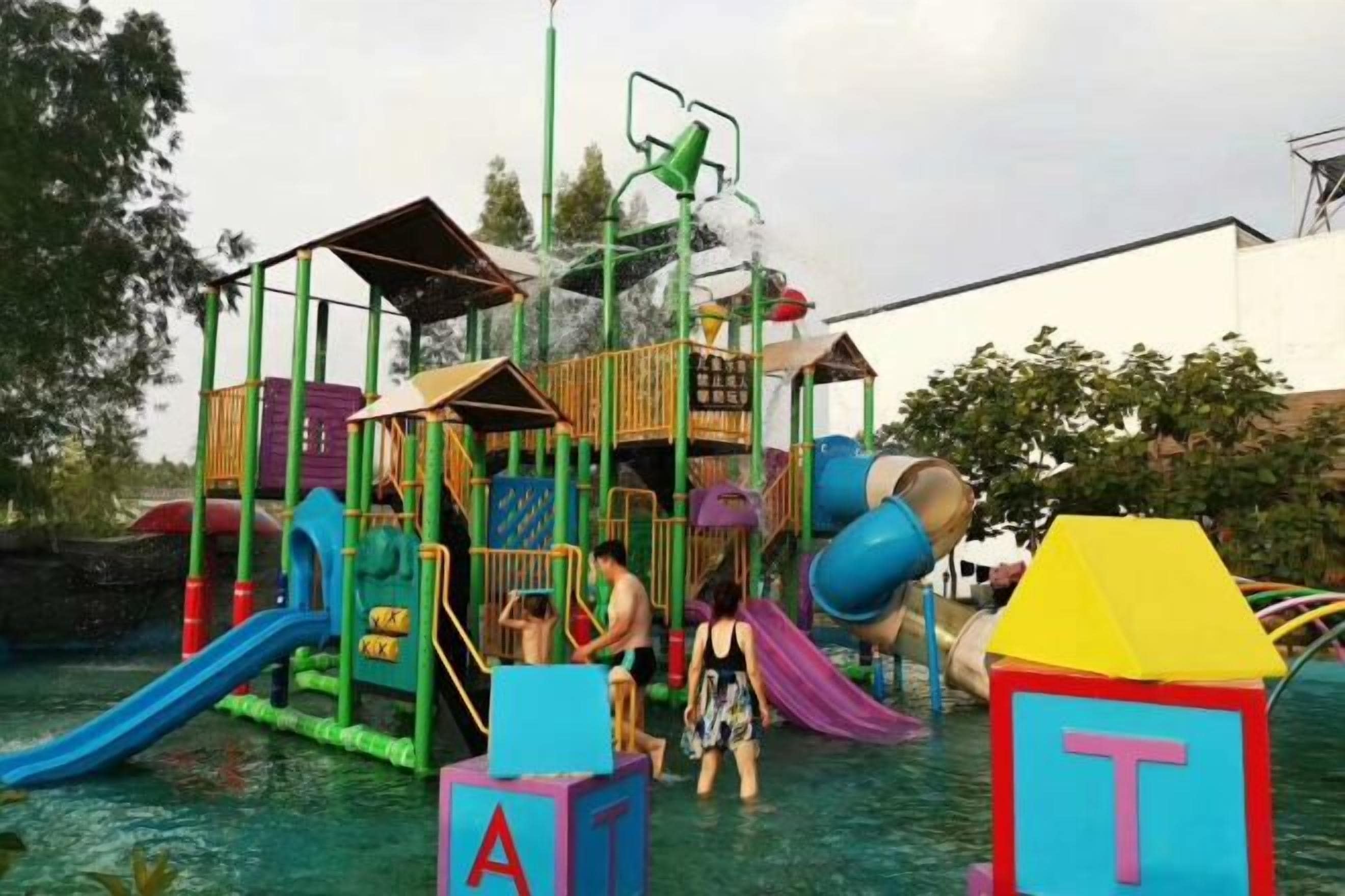 A water play area with slides and climbing structures.