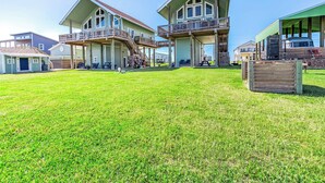 A two-story house with a large front yard and a covered porch. - Beautiful Beachfront Home with Amazing Views, Steps to Beach (Bay City)