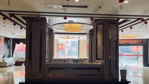 A hotel lobby with a seating area, large windows, and red lanterns. - Huaxia Hotel (Anxi)