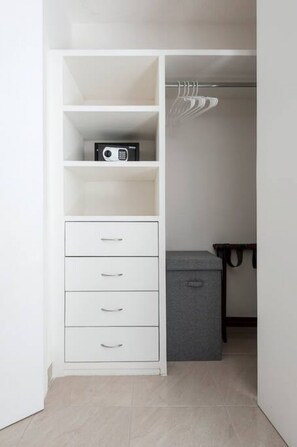 A walk-in closet with white shelving, drawers, and hanging space. - Large 3BR Apartment with exceptional street views (Ciudad de México)