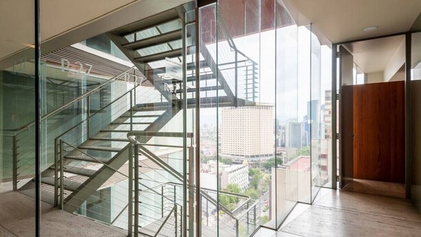 A modern interior with a glass staircase leading to a city view. - Enjoy skyline/city views from this 17th floor flat (Ciudad de México)