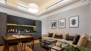Una sala de estar moderna con sofá, mesa de centro y comedor.