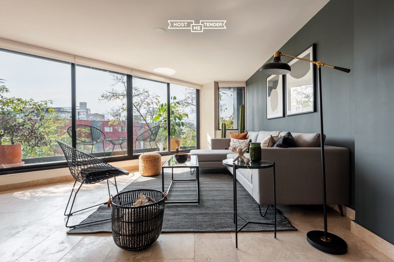 A modern living room with a sofa, chairs, a coffee table, and a floor lamp.