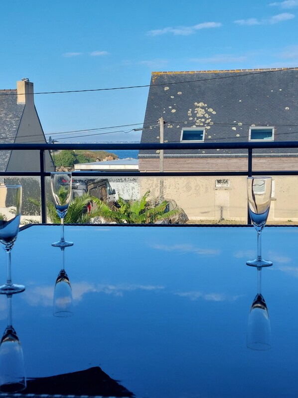 A table with three wine glasses reflecting a building and a clear sky. - House whith sea view at 200 meters from the beach in Plouescat (Plouescat)