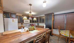 Enjoy cooking in this well-equipped kitchen with a central island, microwave, stove, and various appliances.