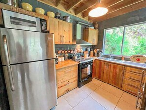 Enjoy cooking in this well-equipped kitchen with a gas stove, refrigerator, and sink.