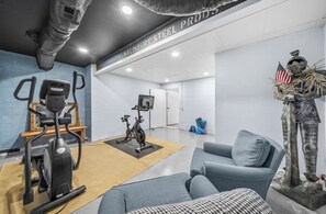 A gym with exercise equipment, a statue, and a wall sign. - Waterfront oasis, tranquil masterpiece for relaxing and recreating beautifully (Centreville)