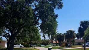 A residential street with houses, a sidewalk, and a driveway. - Sarasota Home Away From Home (Sarasota)