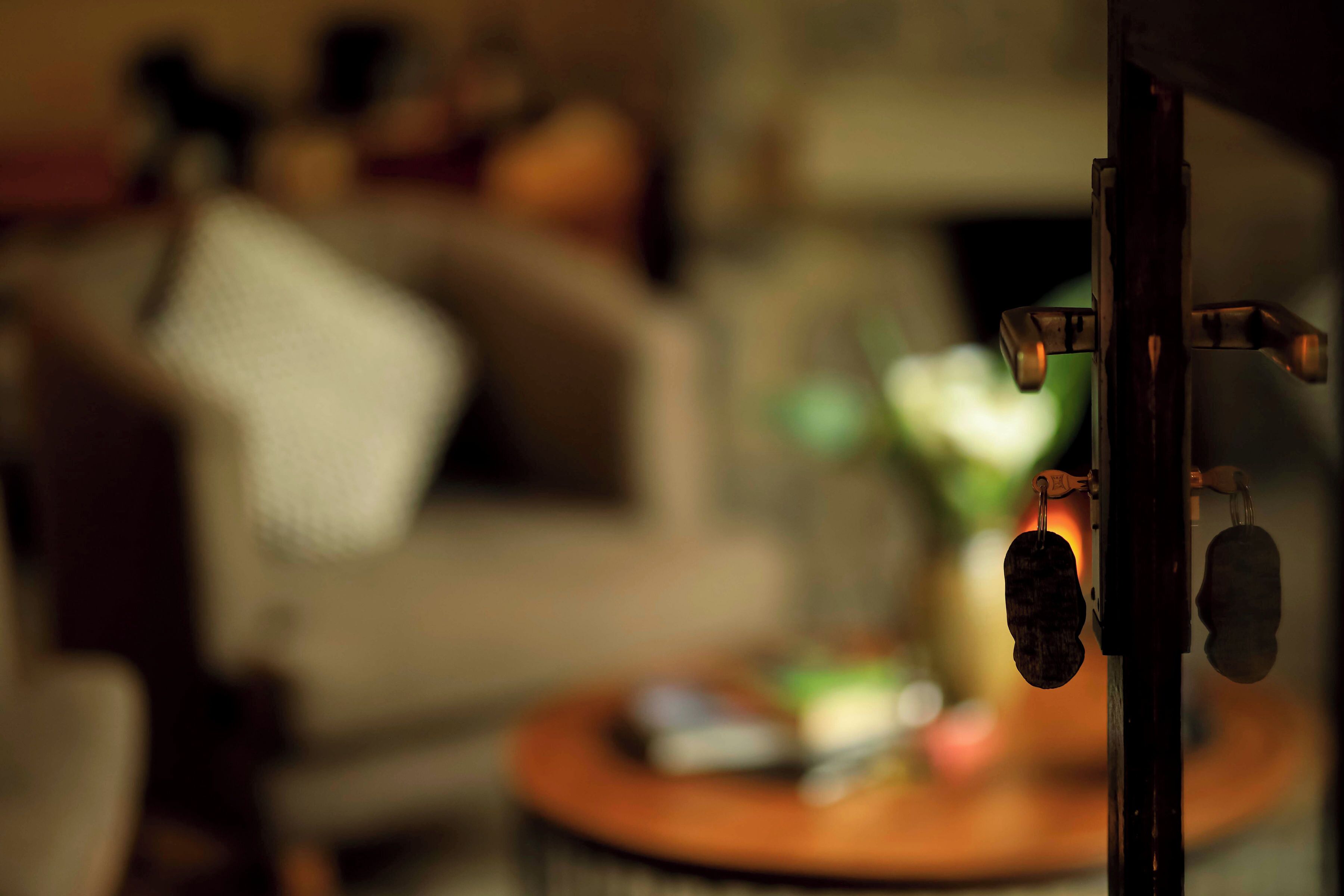 A blurred indoor scene with a round table and a chair.