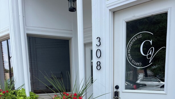 A white building with a number '308' and a logo on the door. - Unique apartment in historic downtown (Vandalia)