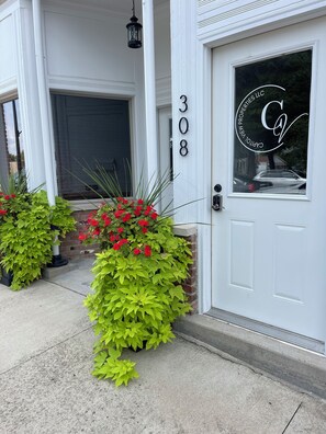 A white building with a number '308' and a logo on the door. - Unique apartment in historic downtown (Vandalia)