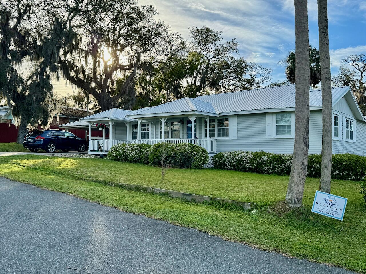 A single-story house with a porch, a garage, and a lawn.