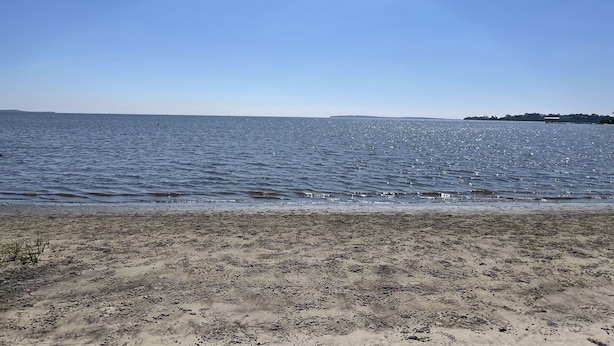 A beach with a sandy shore and calm water. - Osprey Nest- Historic Cedar Key. Pet Friendly! (Cedar Key)