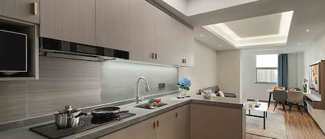 A modern kitchen with a central island, built-in appliances, and a skylight.