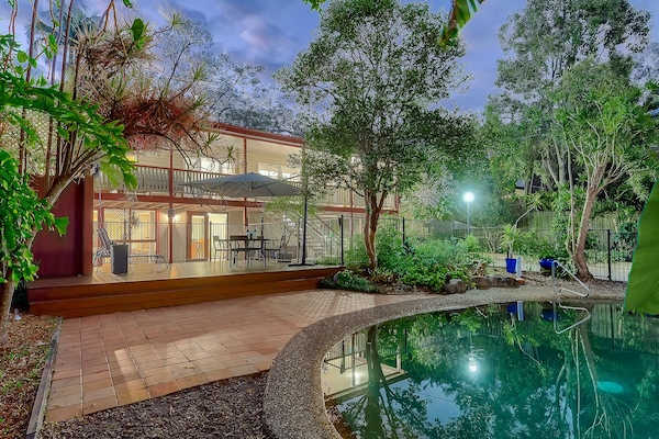 salt water pool and entertainment area with tropical gardens
