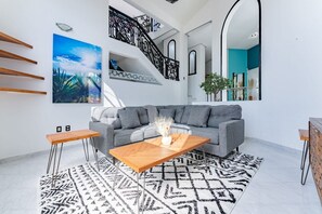 Relax in this stylish living room with a comfortable sofa, coffee table, and area rug.