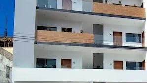 A multi-story building with balconies, large windows, and a flat roof. - Condos FRP (Mazatlán)
