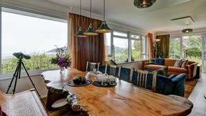 A dining area with a wooden table, chairs, and a tripod. - Gapperies, West Porlock (Porlock Weir)