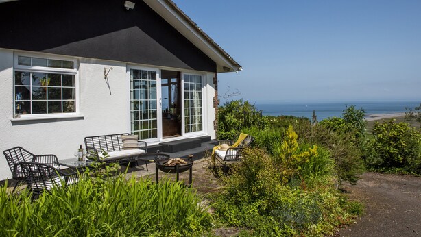 A house with a patio area featuring outdoor furniture and a fire pit. - Gapperies, West Porlock (Porlock Weir)