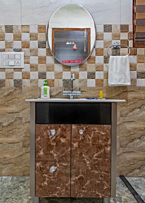 A bathroom with a marble sink, a mirror, and a tiled backsplash. - Grand Kasauli (Kasauli)
