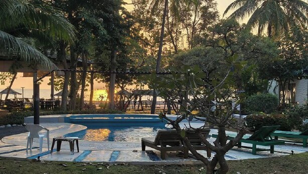 A pool area with a circular design, surrounded by greenery and seating arrangements. - Kalamona Seaview (Sam Roi Yot)