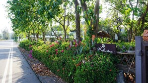 A sign for 'Kolarina' with a garden and trees in the background. - Kalamona Seaview (Sam Roi Yot)