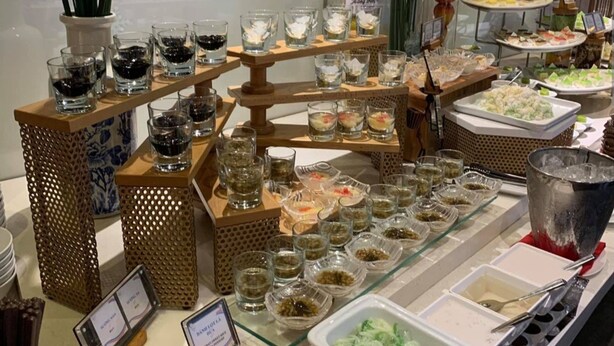 A buffet setup with various food items and beverages. - Aloha Hotel Quy Nhon (Quy Nhon)