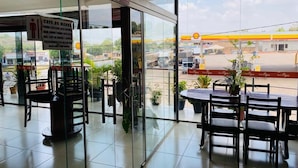 A café with a view of a gas station.