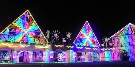 A building with multiple triangular light displays and star-shaped lights.