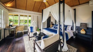 A four-poster bed with a canopy, a wooden ceiling, and a view of greenery outside. - Uma Kalai (Ubud)