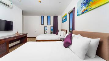 Deluxe Family Room | Minibar, in-room safe, desk, laptop workspace