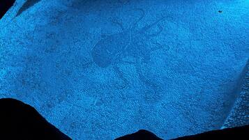 A close-up of a textured surface with a wavy edge, likely a part of a room's interior design.