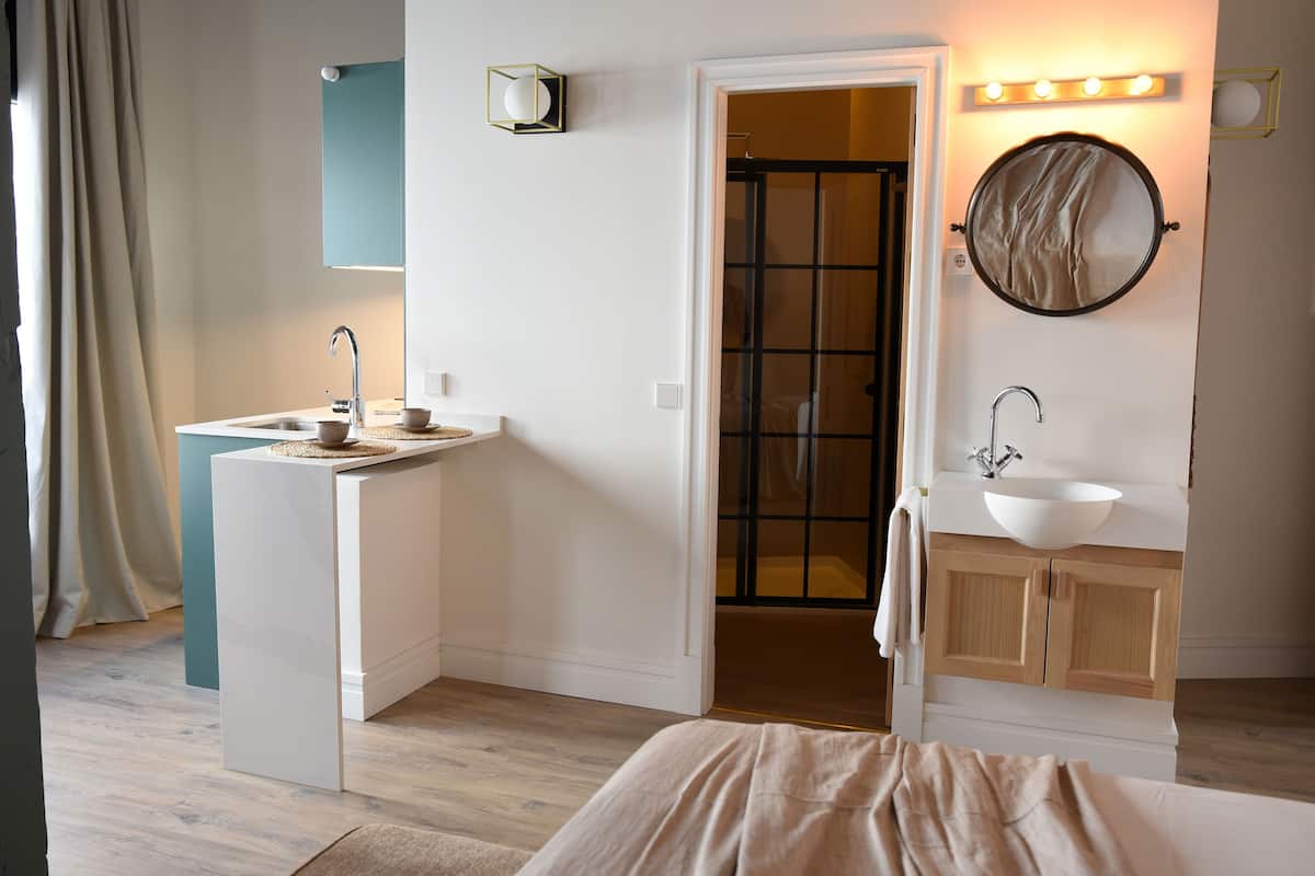 A modern bathroom with a sink, mirror, and vanity.