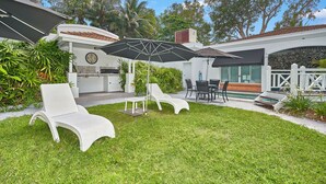 A backyard with a grill, outdoor seating, and a swimming pool. - Alassio 2 Bedroom Direct Pool Access104 (Palm Cove)