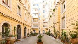 A narrow courtyard with potted plants and a central fountain. - Celestina House - Prati, Rome (updated 2026) (Roma)