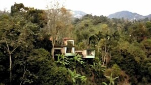A multi-story building surrounded by dense forest and mountains. - Captivating 4-bed Chalet Las Casitas en el Aire (San Francisco)