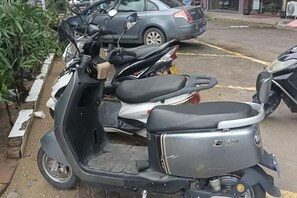 A parked scooter with a visible brand logo on the side. - Youxian Bianjie Hotel (Dongxing)