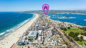 An aerial view of a coastal city with a beach, marina, and dense urban area. - 820.5 Portsmouth Relaunch · Between Mission Bay & Beach Patio, Firepit (San Diego)