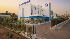A modern hotel with a prominent sign reading "MAURAN AGADIR". - Mia Hotels Agadir (Agadir)