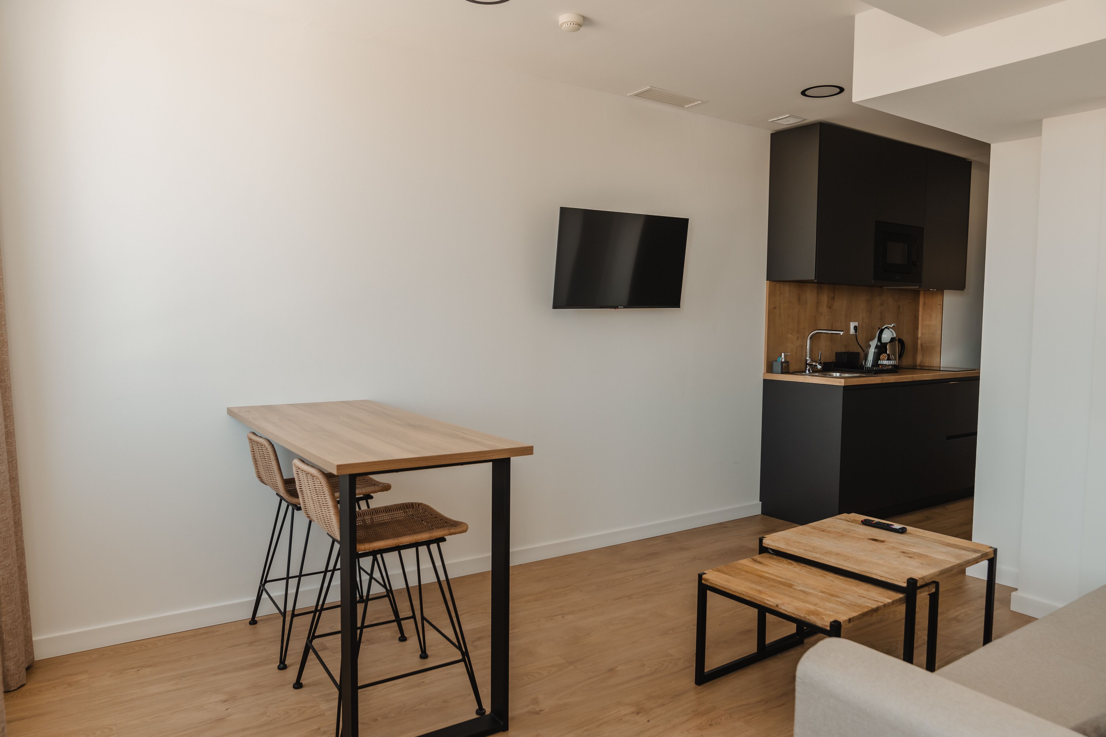 A modern kitchen with a wooden countertop, a built-in microwave, and a sink.