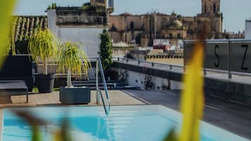 Seasonal outdoor pool, open 9:30 AM to 7:30 PM, pool umbrellas