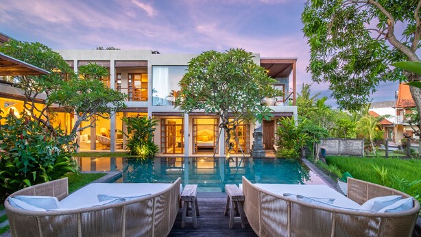 A modern house with a swimming pool, wicker furniture, and lush greenery. - Stunning 4BR Private Villa in Canggu (Canggu)