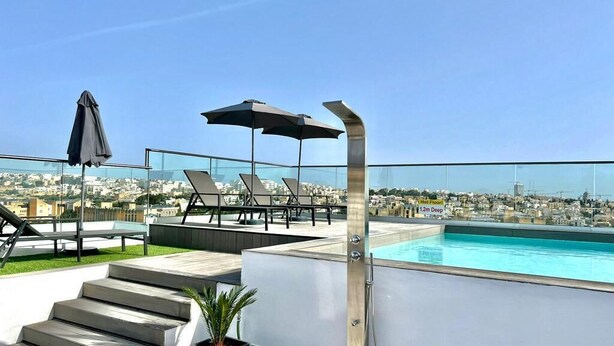 A rooftop pool area with a clear view of the cityscape, a hot floor, and a 1.2m deep pool. - Park Heights by the Warren Collection (Msida)