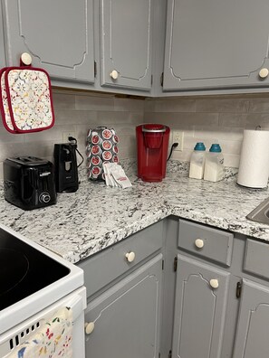 Enjoy cooking in this well-equipped kitchen with a granite countertop, coffee maker, toaster, kettle, and more.