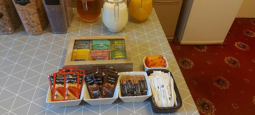 A breakfast buffet with various food items and condiments.