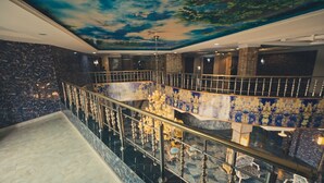 A grand staircase with a marble floor leading to a balcony with a view of the sky. - Candellux Imperial Hotel and Suites (Abuja)
