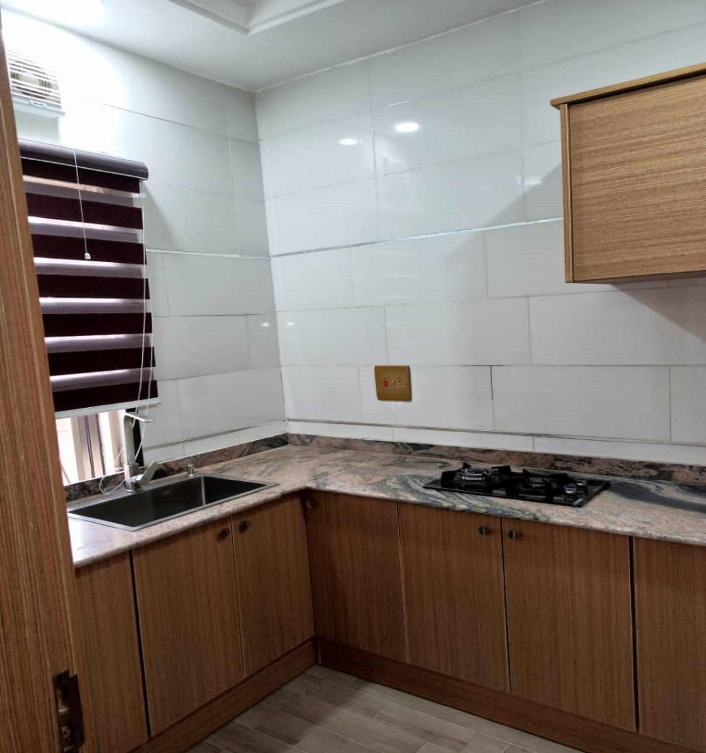 Fridge, electric kettle, cleaning supplies