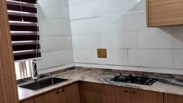 Fridge, electric kettle, cleaning supplies